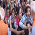 The woman holding the Prime Minister's hand.. Modi glared at the security guard who went to stop him!